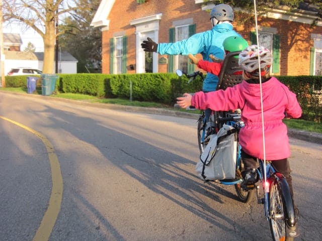 dad and kids ridin a bicycle