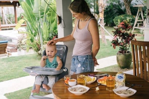 mother with baby on high chair
