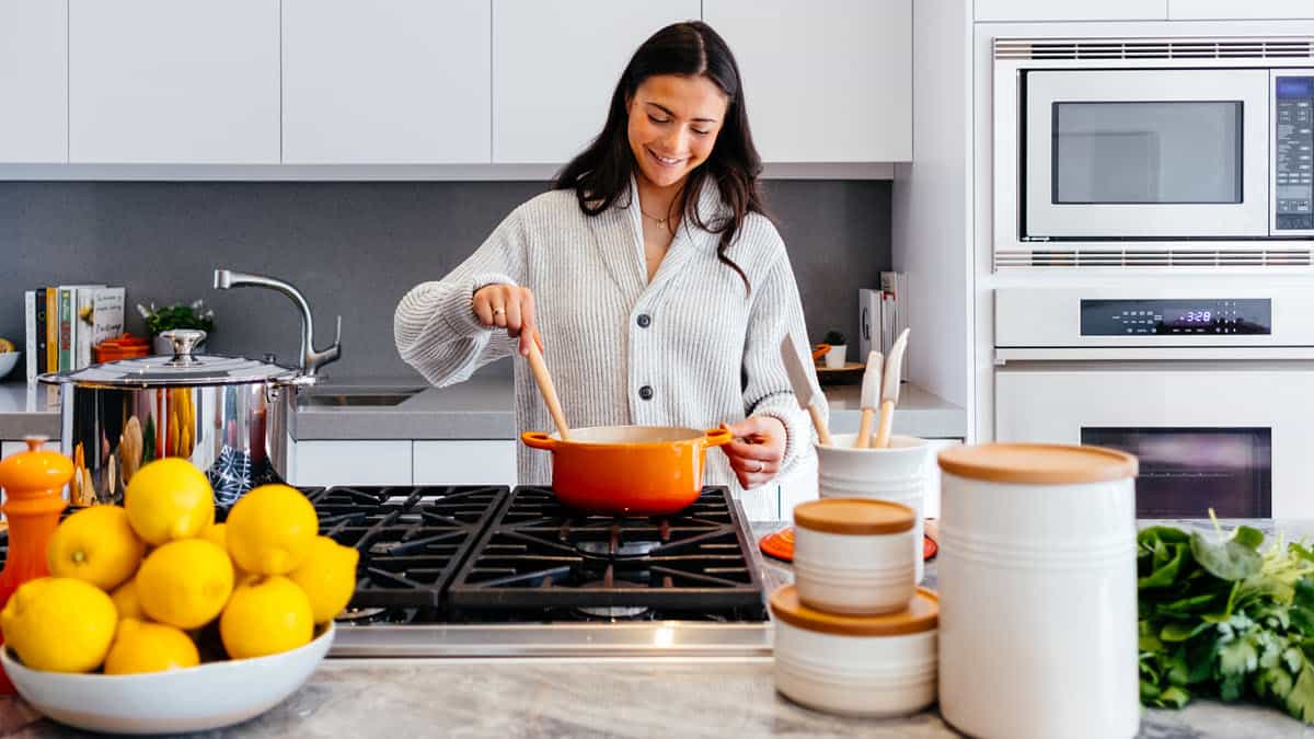 Dark haired woman cooking in a kitchen