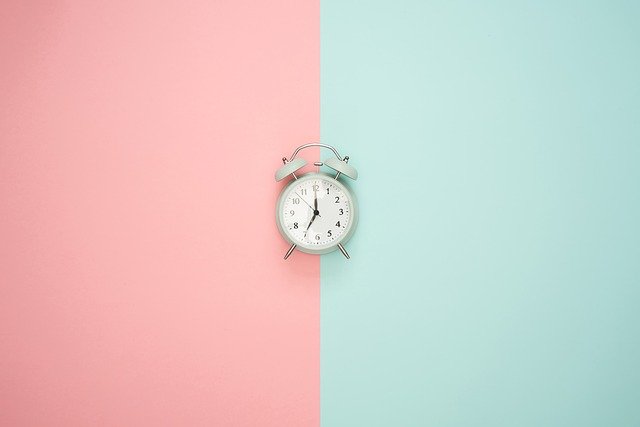 Old fashioned clock against two tone background