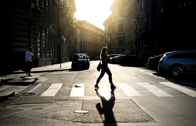 Woman crossing the road at a pedestrian crossing