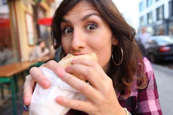 Woman taking a bit of a sandwich