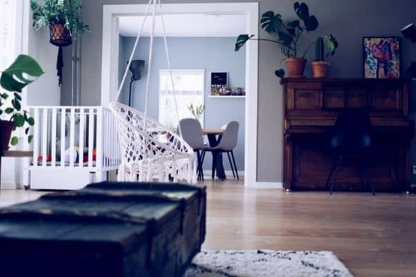 baby crib and swing in the living room