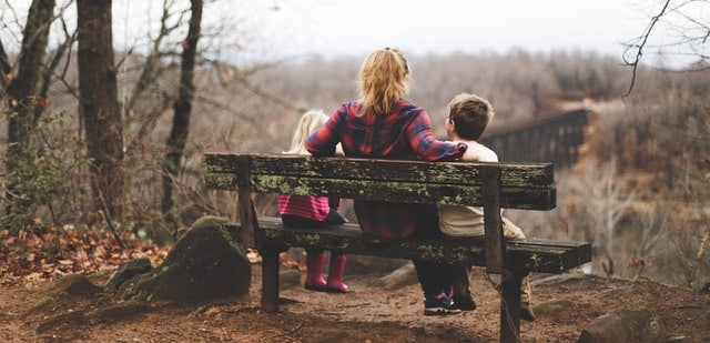mother and children sitting outdoors
