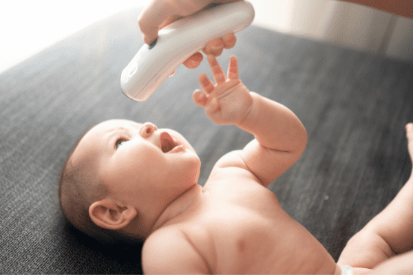 checking baby with Infrared thermometer