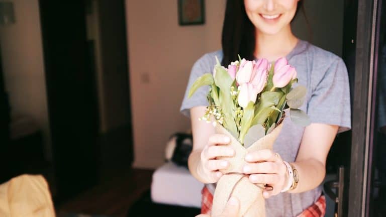 Young woman receiving a bouquet of flowers