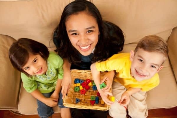 baby sitter with two children