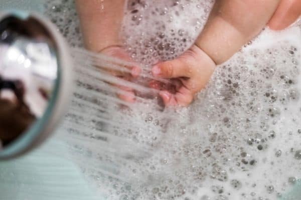 kid playing shower water