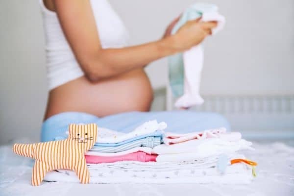 pregnant woman sorting baby stuff