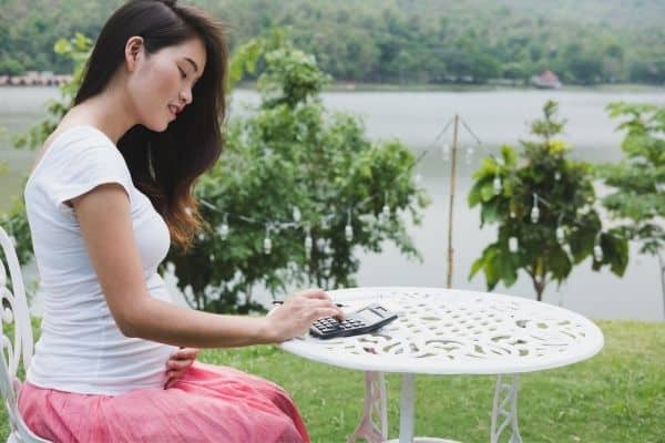 pregnant woman using a calculator