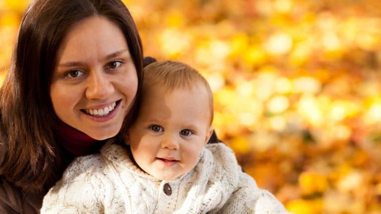 Smiling young mother with happy baby
