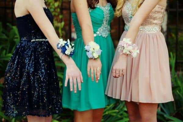teens wearing prom dresses