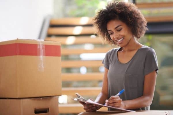 woman listing items for moving