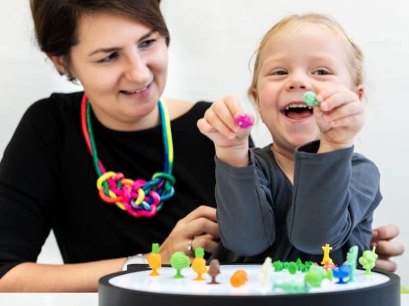Occupational therapist helping a young child