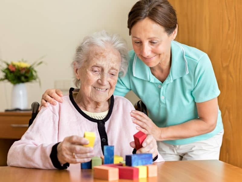 Occupational therapist helping an old woman