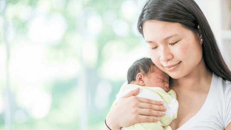 Young mother caring for her newborn baby