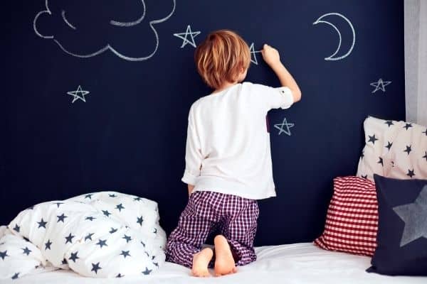 kid doodling on bedroom wall