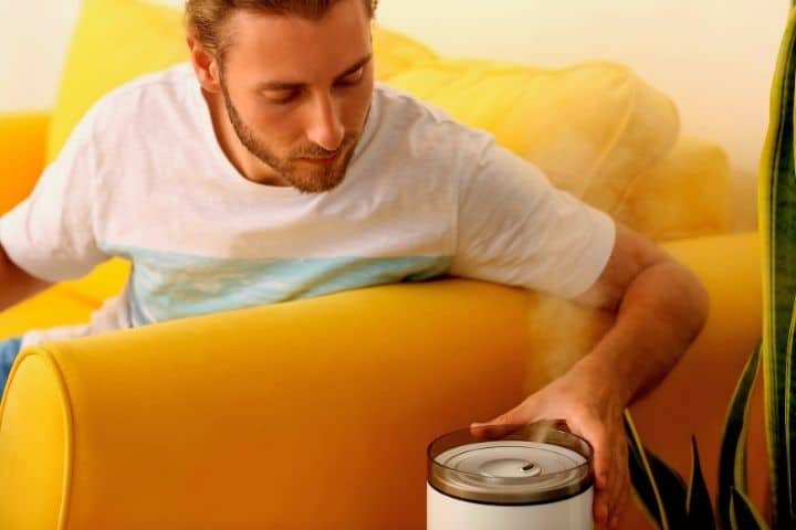 A Man Holds Humidifier