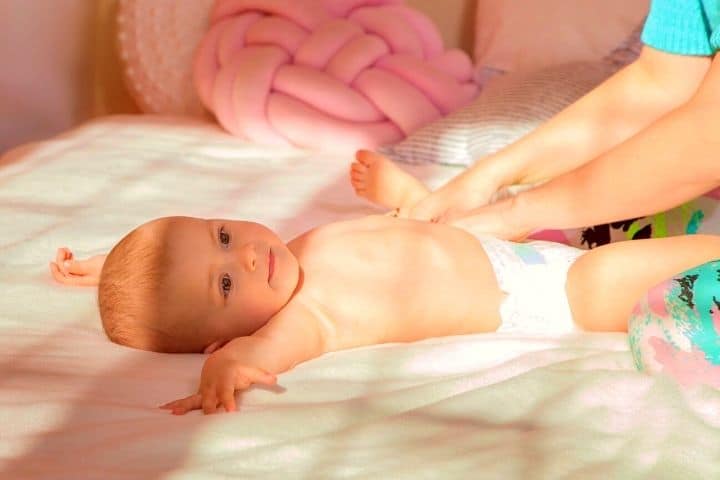 A Woman Changes Her Baby's Diaper 