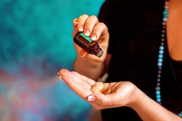 A Woman Pours An Essential Oil On Her Hand