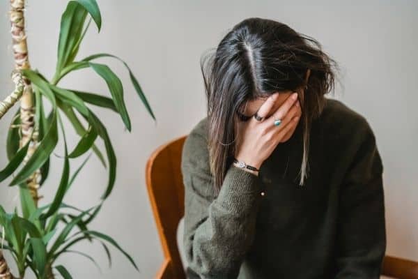 Anxious Woman Sitting On A Corner