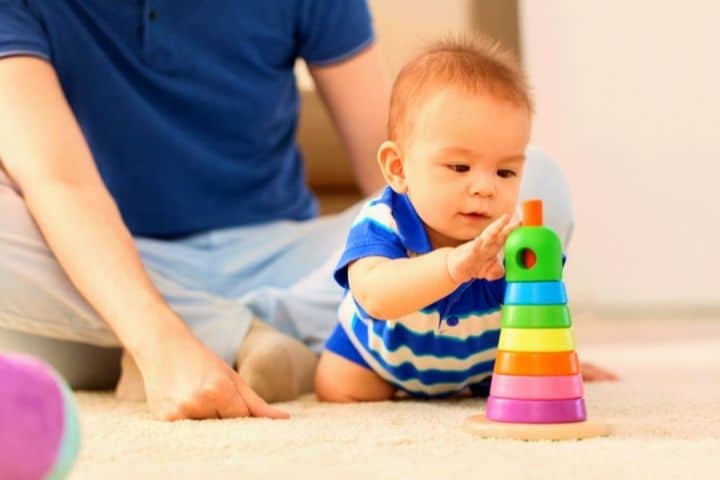 Father Plays With Child On Carpet