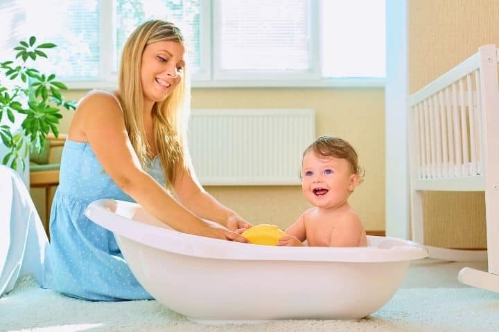 Mom Bathes The Baby