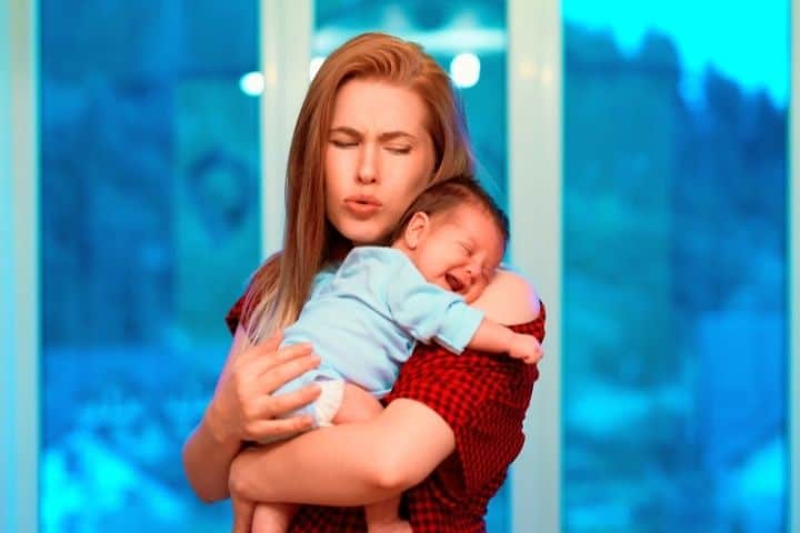 Mom Calms Baby Crying In Her Arms