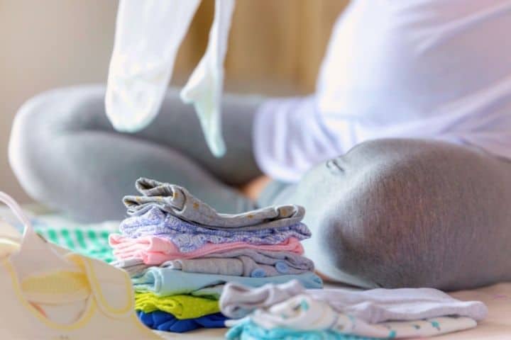 Mom Is Sorting Through Baby Clothes