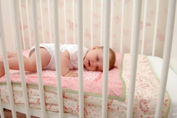 Pretty Baby Lying On Cot Sheets
