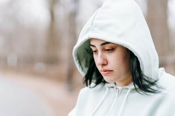 Visibly Upset Person Thinking While Sitting In A Park
