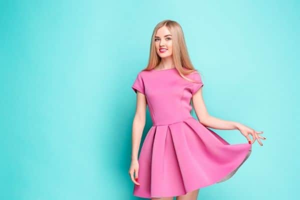 Woman Wearing Short Pink Dress On Blue Background