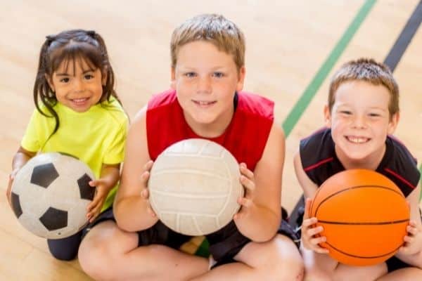 Children Holding Different Sports Balls
