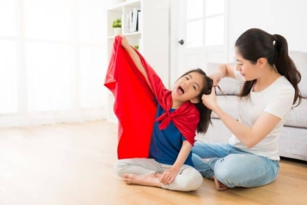 Mother Tying Child's Hair