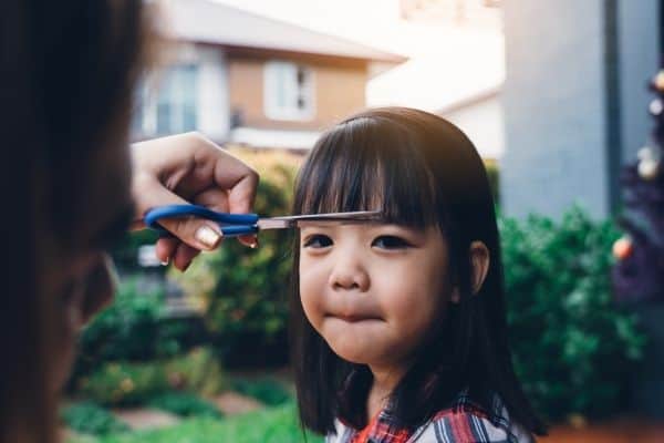 Mum Cutting Child's Hair At Home