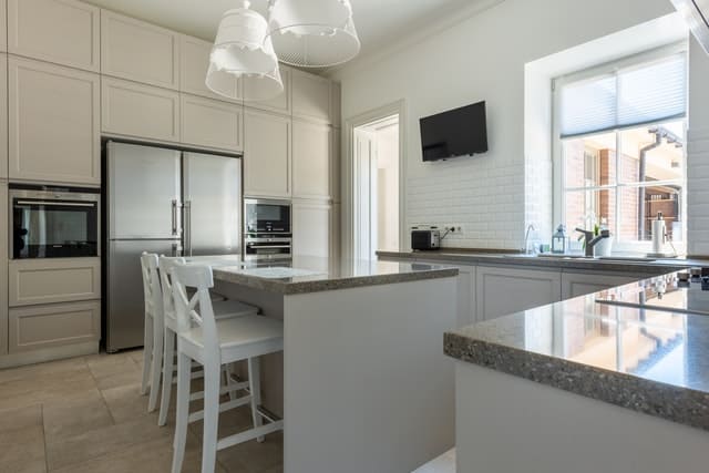 Simple Kitchen With White Wooden Barstools