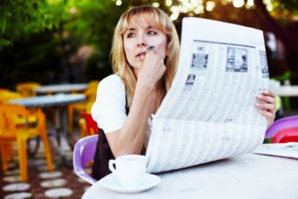 Woman Holding A Newspaper