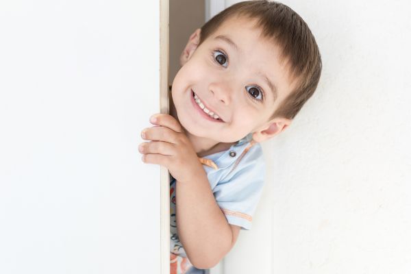 Child Peeking From The Door