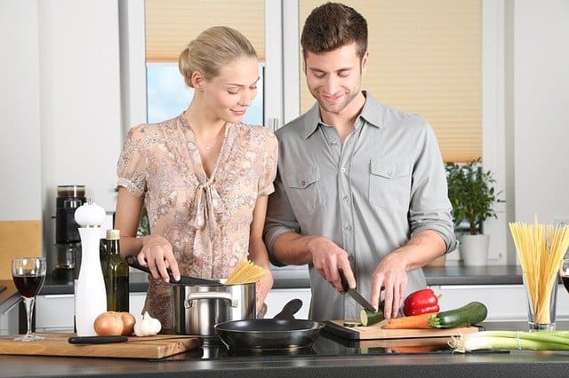 Couple Preparing Meal In The Kitchen