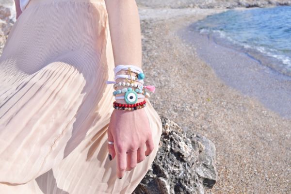 Woman Wearing Bohemian Jewelry Strolling On The Beach
