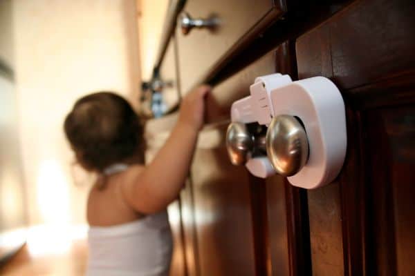 Toddler Exploring Child Proof Cabinet