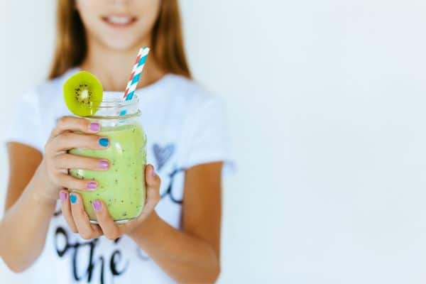 Person Holding A Jar Of Smoothie