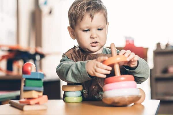 Young Boy Playing Montessori Toys 