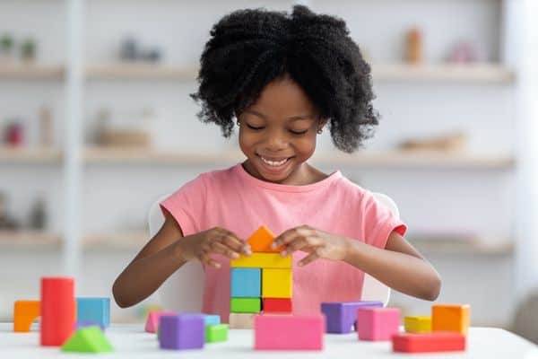 Young Girl Playing With Educational Blocks