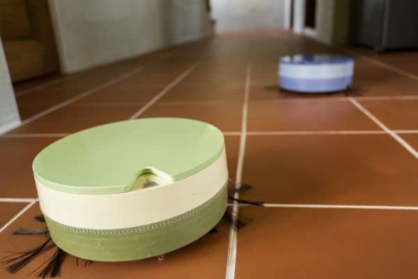 Two Robot Vacuum Cleaners Cleaning Floors