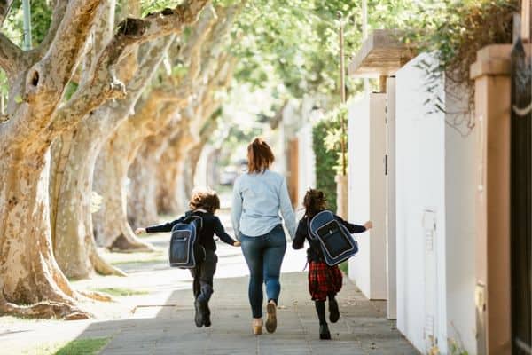 Mother And Kids On The Way To New School