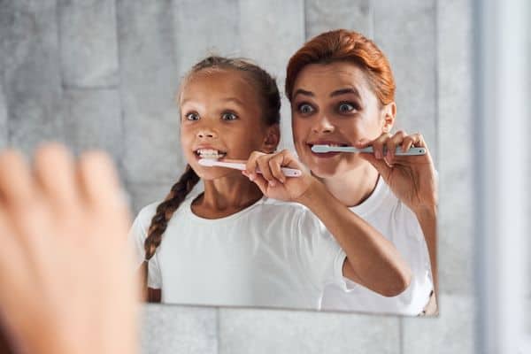 Parent And Child Brushing Teeth