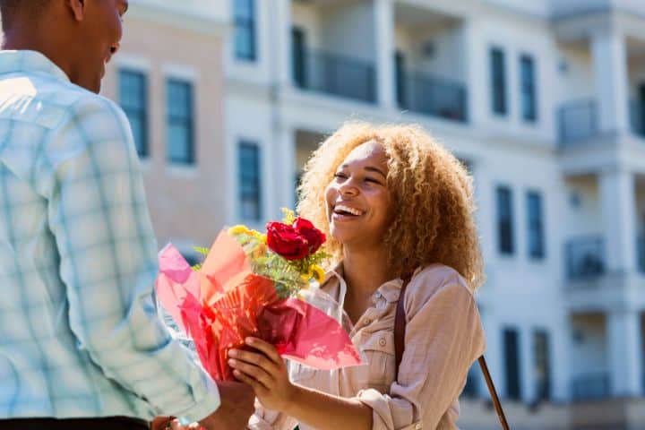 A Man Gives A Woman Flowers