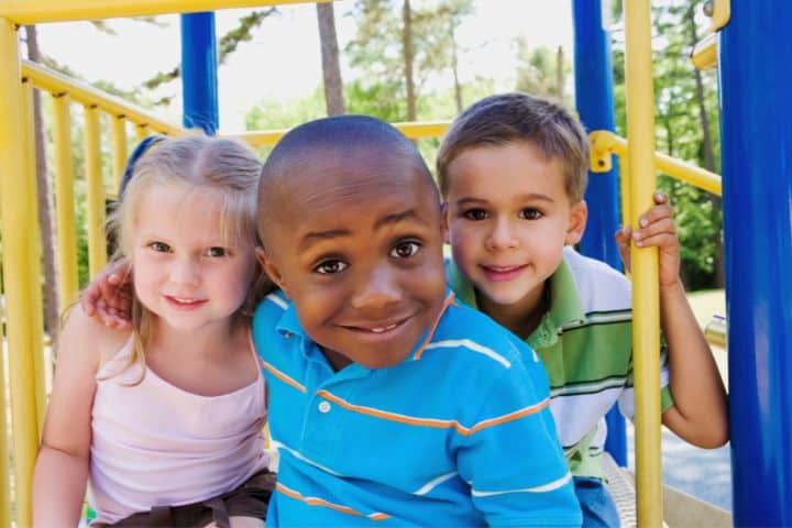 Happy Children Playing On The Playground