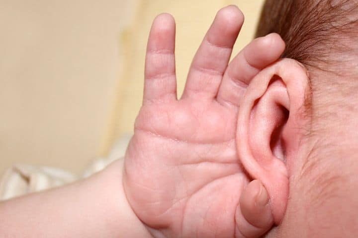 The Child Put His Hand To His Ear